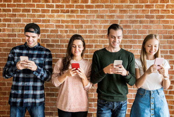 Joves mirant els seus mòbils, on es poden descarregar l'app Closely.